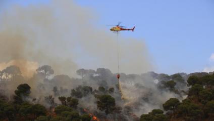 Helicòpter llançant aigua a l’incendi de Castell d’aro