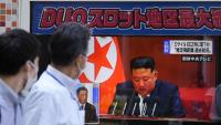 Dos vianants observen una pantalla on apareix el líder de Corea del Nord, Kim Jong-un, a Tòquio