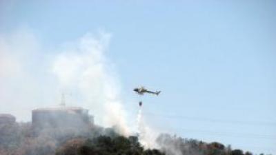 Un helicòpter sobrevola una zona afectada pel foc, ahir.  ACN