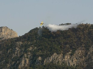 Un hidroavió remullant una de les muntanyes fumejants del massís dels Ports.  J.F