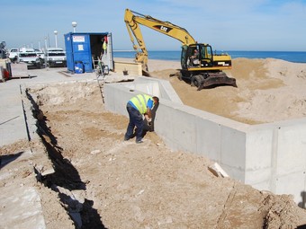 Màquina excavadora que realitza obres de restauració a la platja. /  ARXIU