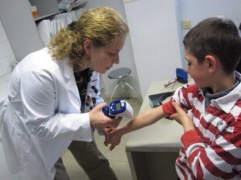 La dermatòloga del Pius Hospital de Valls, examina un lunar al braç d'un infant. A. ESTALLO