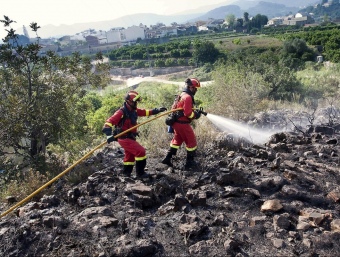 Membres de la UME treballen en l'extinció del foc pròxim al nucli urbà . ARXIU