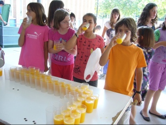 Un grup d'escolars prenen el suc de taronja a l'hora del pati. CEDIDA