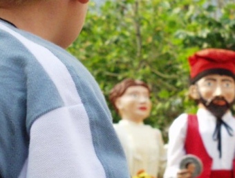 Un nen es mira la cercavila de gegants durant la festa major del Masnou.  Q. PUIG