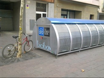 Una estació del Bicibox a la rambla Salvador Lluch de Gavà, amb una bicicleta lligada al costat R.M.B