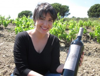 Anna Espelt enòloga del celler Espelt, amb una ampolla de ComaBruna a les vinyes velles. ESPELT VITICULTORS