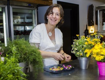 Iolanda Bustos preparant un plat fet amb flors, en una imatge de l'any passat. JORDI RIBOT/ICONNA