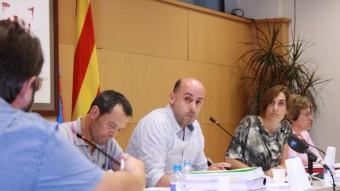 El regidor de Junts Jordi Oriol, en primer pla, observat per l'alcalde Xavi Sala (ERC) i Sònia Pujol (Guanyarem), durant el ple. JOAN PUNTÍ