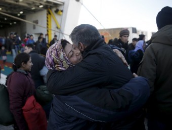 Una parella de refugiats s'abraça aquest divendres al desembarcar al port del Pireu, a prop d'Atenes, procedents de l'illa de Lesbos REUTERS