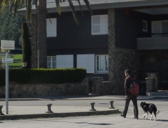 Un home amb un gos creuant ahir al matí la plaça de l'Ajuntament de Camós. R. E