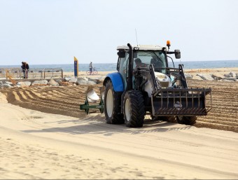 Un dels tractors que ahir va estar fent les tasques de llaurar les platges de Barcelona per preparar-les de cara a la temporada de bany ANDREU PUIG
