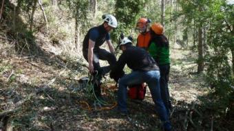 Un formador del Centre de Formació Forestal Especialitzada es col·loca els arnesos en una classe de trepa A. A