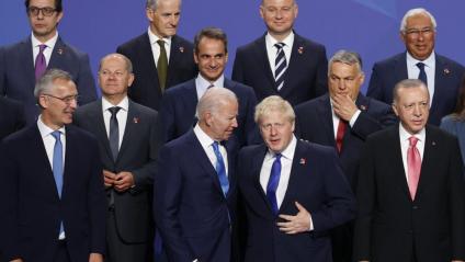 El president dels Estats Units, Joe Biden, i el primer ministre britànic, Boris Johnson, conversen en presència d’altres dignataris mentre esperen per fer-se la foto oficial de grup